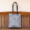 light gray waxed bag with leather strap