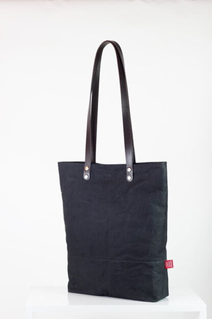 Black waxed tote bag with leather strap